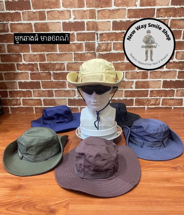 Outdoor wide-brim hats in beige, green, purple, blue, and black displayed on a wooden desk.