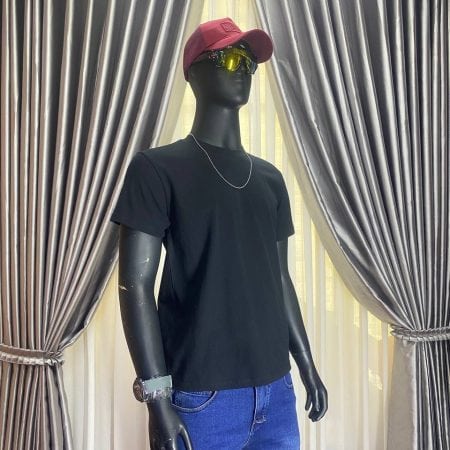 Black t-shirt, red cap, yellow sunglasses, and blue jeans on mannequin.