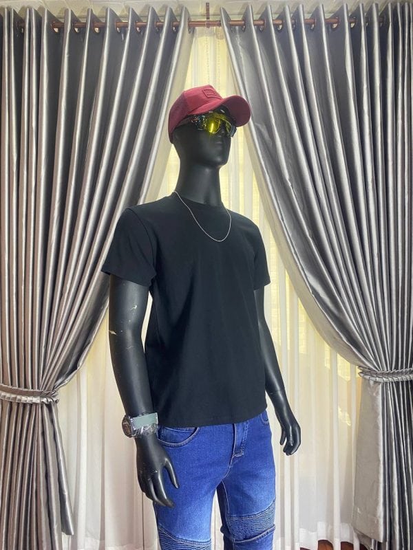 Black t-shirt, red cap, yellow sunglasses, and blue jeans on mannequin.