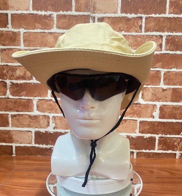 Beige wide-brim outdoor hat with black chin strap and sunglasses on mannequin head.
