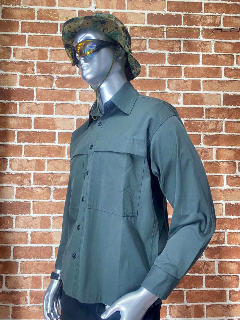 Green tactical shirt with long sleeves and button-up front.