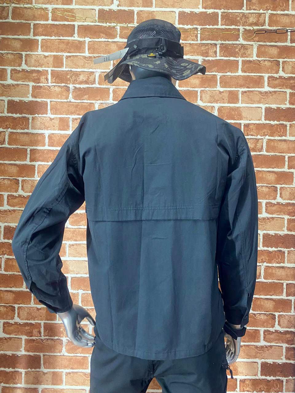 Black tactical jacket with hat, suitable for outdoor activities.
